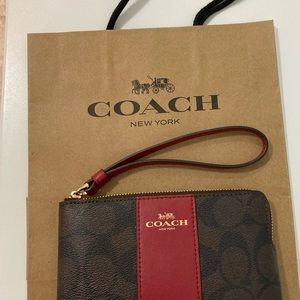 NWOT Signature canvas/red leather coach wristlet  Measures 6"x4".